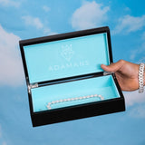 Premium Adamans Box luxury jewelry storage with turquoise interior and diamond bracelet inside against blue sky background
