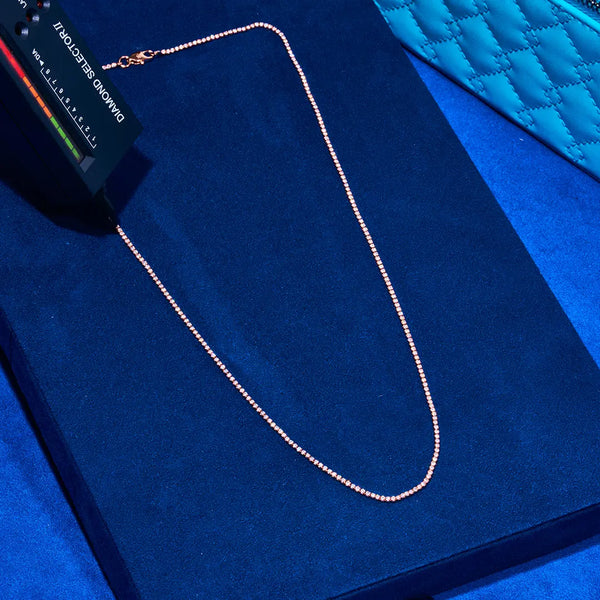 Rose gold micro tennis chain on blue velvet display with diamond selector tool