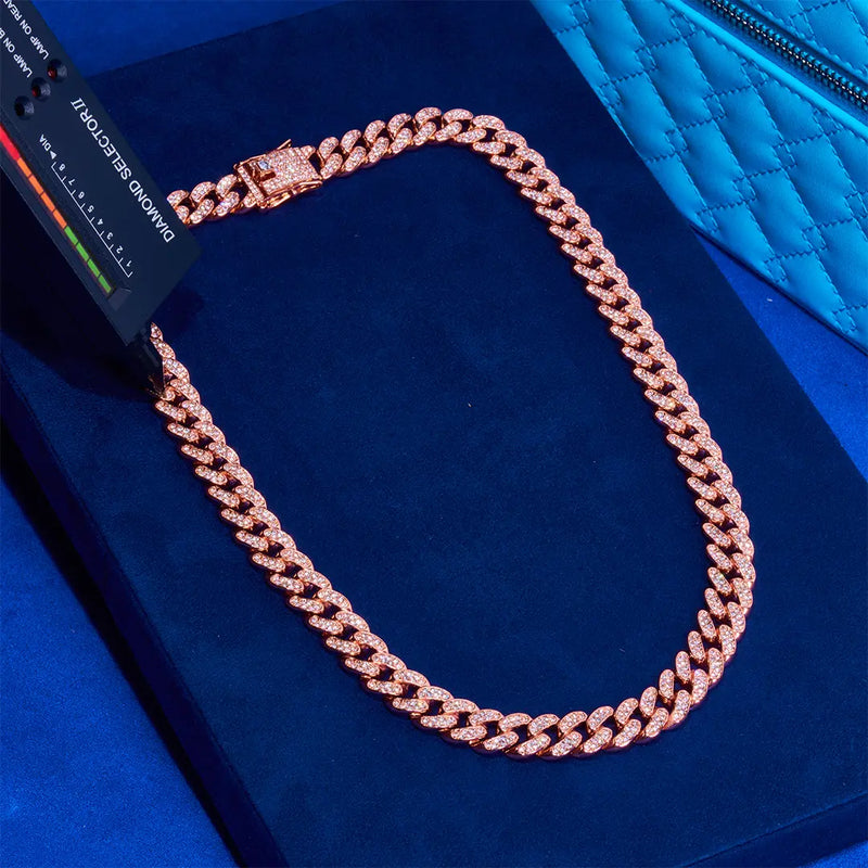 13mm rose gold Cuban chain with diamond simulant stones on blue velvet background