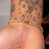 3mm Moissanite Tennis Bracelet in 18k Vermeil on wrist with tattoos.