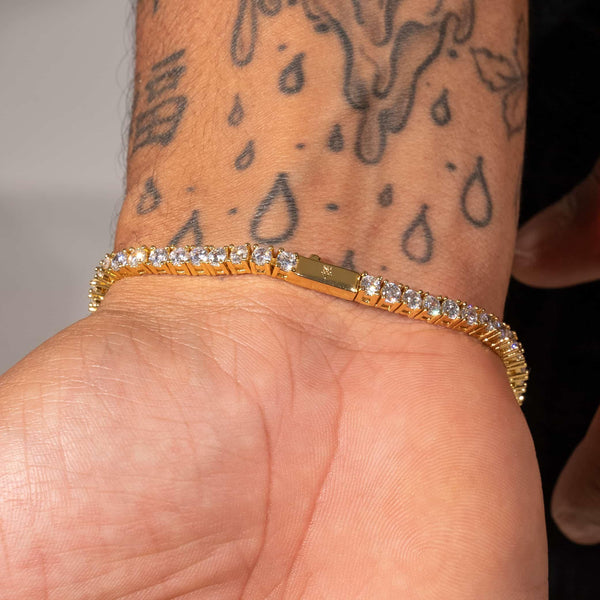 3mm Moissanite Tennis Bracelet in 18k Vermeil on wrist with tattoos.