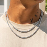 3mm white gold tennis chain with prong-lifted stones catching light.