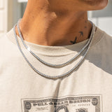 3mm Tennis Chain in White Gold with prong-lifted stones on a person's neck.