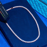 6mm rose gold tennis chain with round cut diamond simulants on blue velvet background