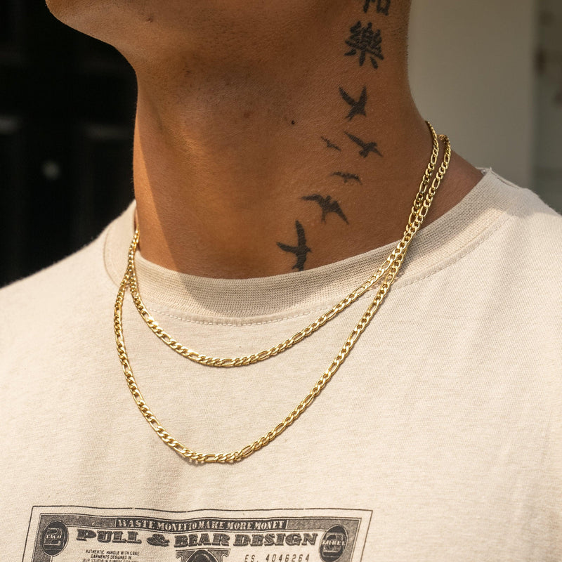 4mm Figaro Chain in gold on person wearing a beige shirt.