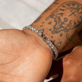 5mm white gold tennis bracelet with diamond simulants on tattooed wrist.