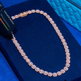 10mm Clustered Tennis Chain rose gold with sparkling clustered stones on blue velvet background
