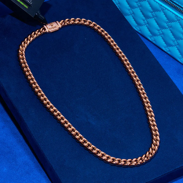 10mm rose gold Cuban iced clasp chain on blue background