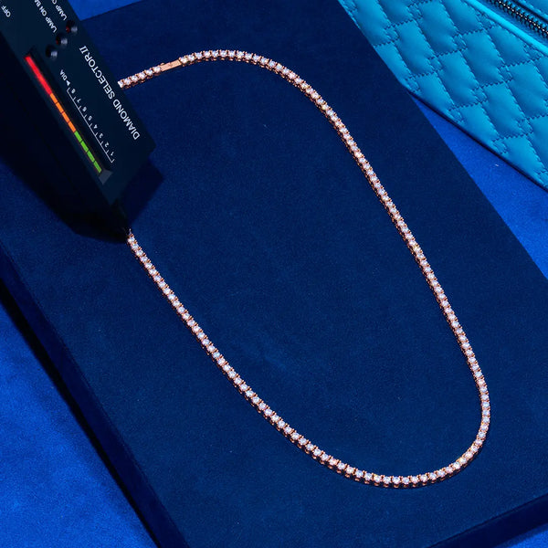 3mm rose gold tennis chain with prong-lifted diamond simulant stones on blue velvet background