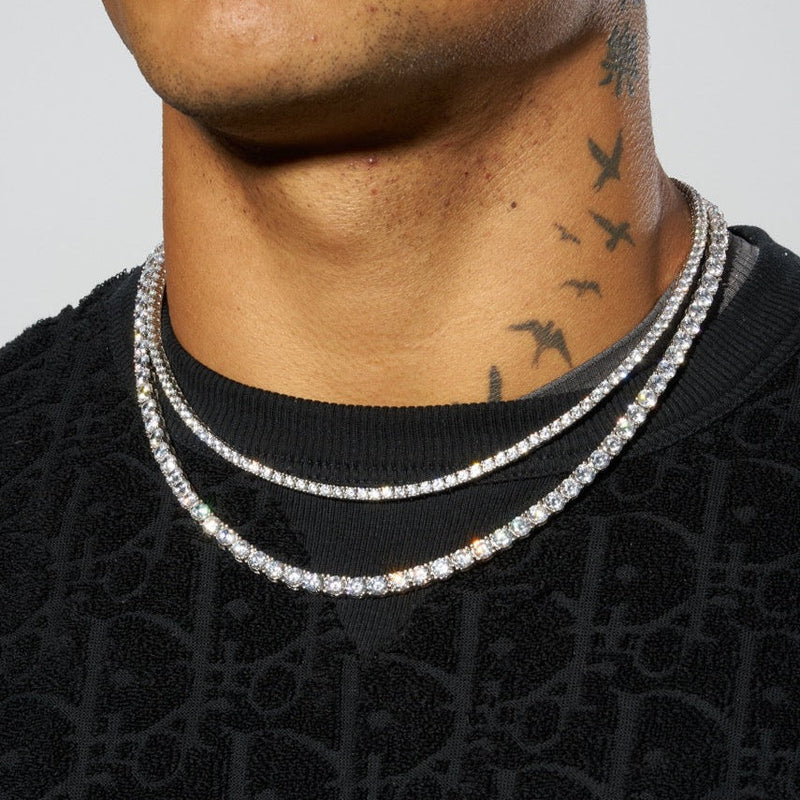 3mm and 5mm white gold tennis chain bundle layered on neck.