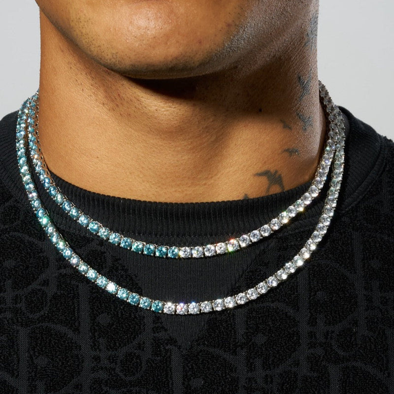 5mm pale blue and white tennis chain in white gold on neck, showcasing intricate prong-lifted stones.