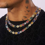 10MM Moissanite Multi Gemstone Chain in 925 Silver on neck, featuring colorful stones.