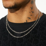 4mm Figaro Chain in white gold on a person with black shirt.