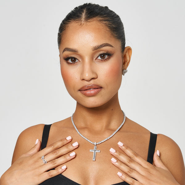 Woman wearing 18K white gold iced cross pendant necklace with prong-lifted diamond simulant stones