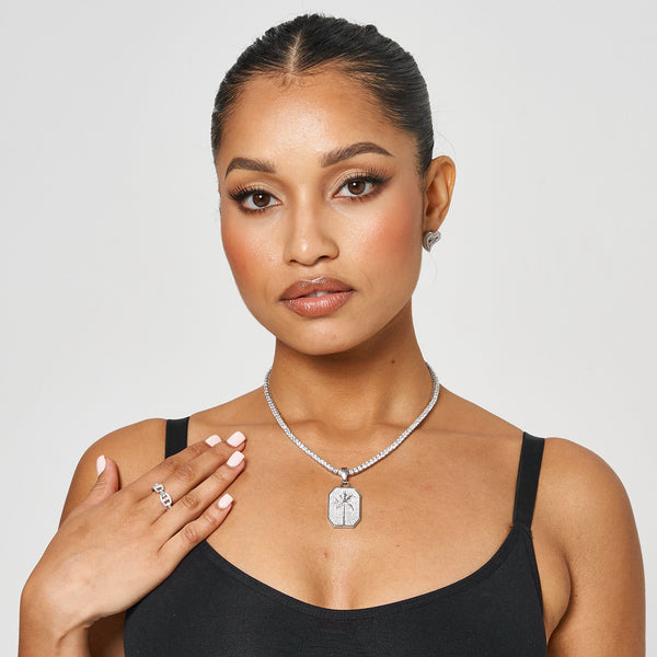 woman wearing white gold palm tree pendant necklace with matching ring