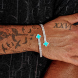 8MM Moissanite Green Motif Baguette Bangle in white gold plating on 925 silver wrist with vibrant green baguette-cut stones and VVS1 clarity