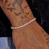 3MM Moissanite Round & Star iced tennis bracelet in 925 silver worn on wrist with bird tattoos