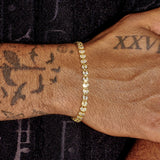 Gold broken heart bracelet with diamond simulants on wrist