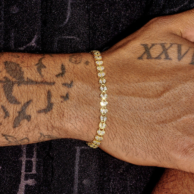 Gold broken heart bracelet with diamond simulants on wrist