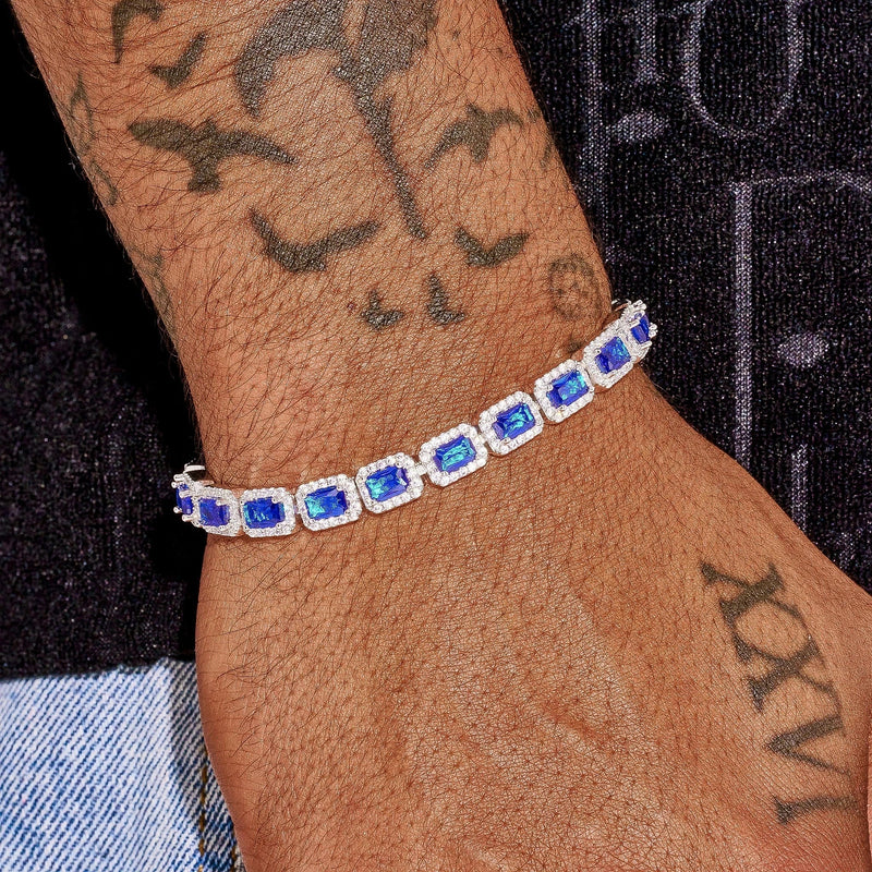 Sapphire cushion cut tennis bracelet in white gold with vivid blue stones on wrist