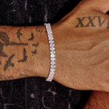 6MM Pear Cut Tennis Bracelet in white gold on wrist with tattoos