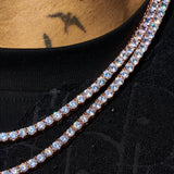 Close-up of 5mm Moissanite tennis chain in rose gold with sparkling round stones on a black shirt