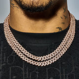 Close-up of a man wearing a 10mm Moissanite Monaco Chain in rose gold with sparkling VVS1 D Colour stones on black shirt