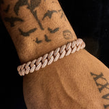 8mm Moissanite iced Cuban link bracelet in rose gold on wrist with tattoos