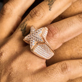 Close-up of a hand wearing a rose gold Moissanite Iced Star Ring with 925 silver and VVS1 stones