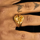 Gold Broken Heart Ring with yellow gemstone worn on finger, symbolizing bold elegance and unique style