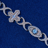 Close-up of Moissanite Baguette Cross Evil Eye Chain in 925 silver with baguette-cut stones and evil eye motif on blue background