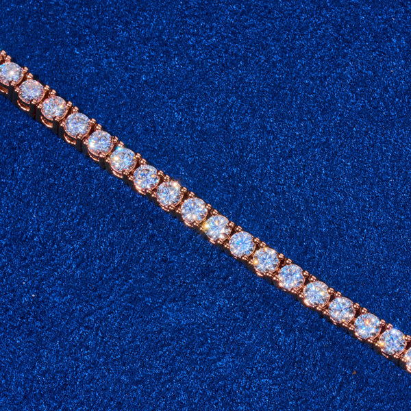 3mm rose gold tennis chain with round cut diamond simulant stones on blue background