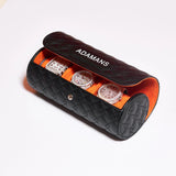 Black leather travel watch roll with orange interior holding three luxury watches by Adamans