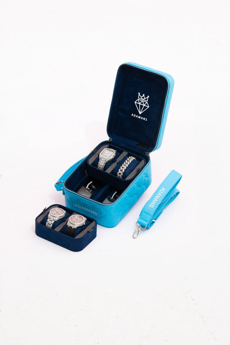 Small blue leather travel jewellery case with stackable suede trays and adjustable strap displaying watches and bracelets