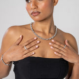 Woman wearing 8mm iced infinity chain white gold necklace with matching rings and bracelet