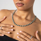 5mm white and green heart tennis chain necklace in white gold worn by woman