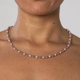 Close-up of a 5mm iced and plain ball chain necklace with two-tone gold plating worn on neck