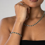 3mm green and white tennis bracelet in white gold worn on wrist and neck