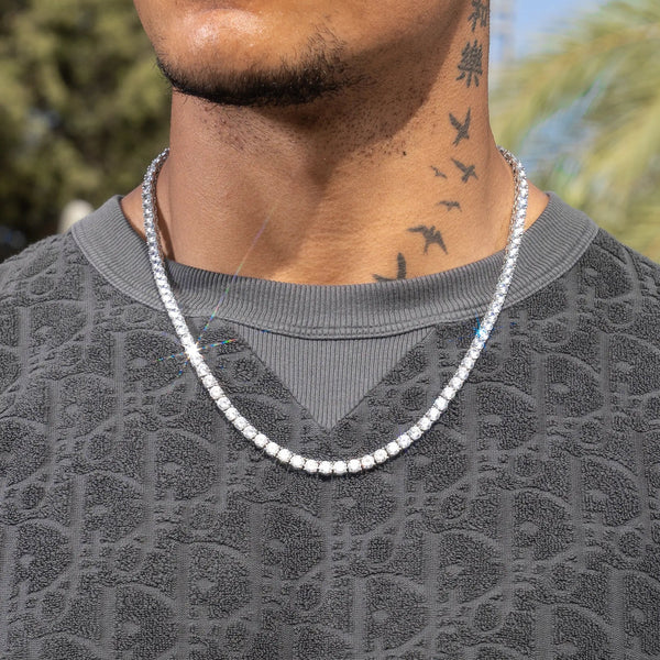 5mm IGI diamond tennis chain in white gold, worn by a person outdoors.