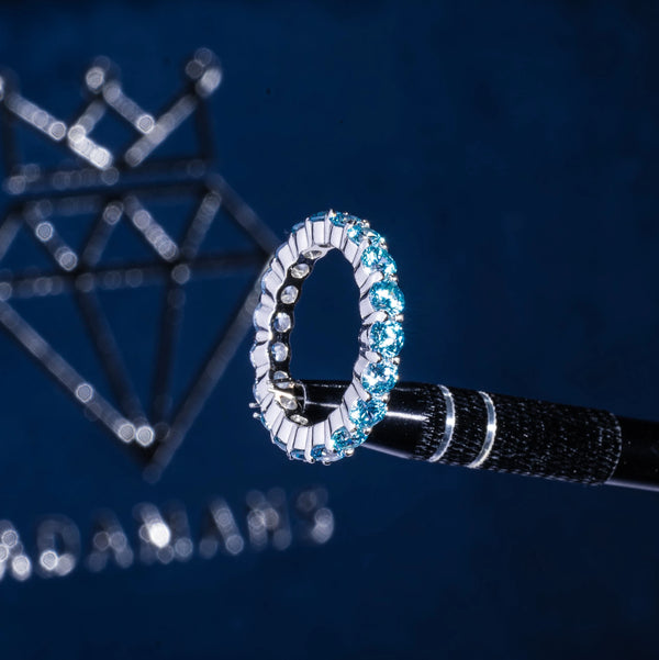 Light blue lab diamond tennis ring in 925 silver with VVS1 clarity and D color stones.