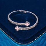 8MM Pink Motif Baguette Bangle in white gold with pink baguette-cut stones on navy blue velvet background