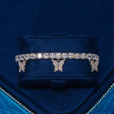 Iced Butterfly Tennis Bracelet in white gold with butterfly motifs and shimmering stones in a blue velvet display box