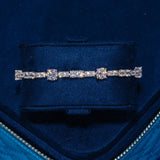 Gem Stationed Tennis Bracelet in white gold with sparkling CZ stones on navy velvet background