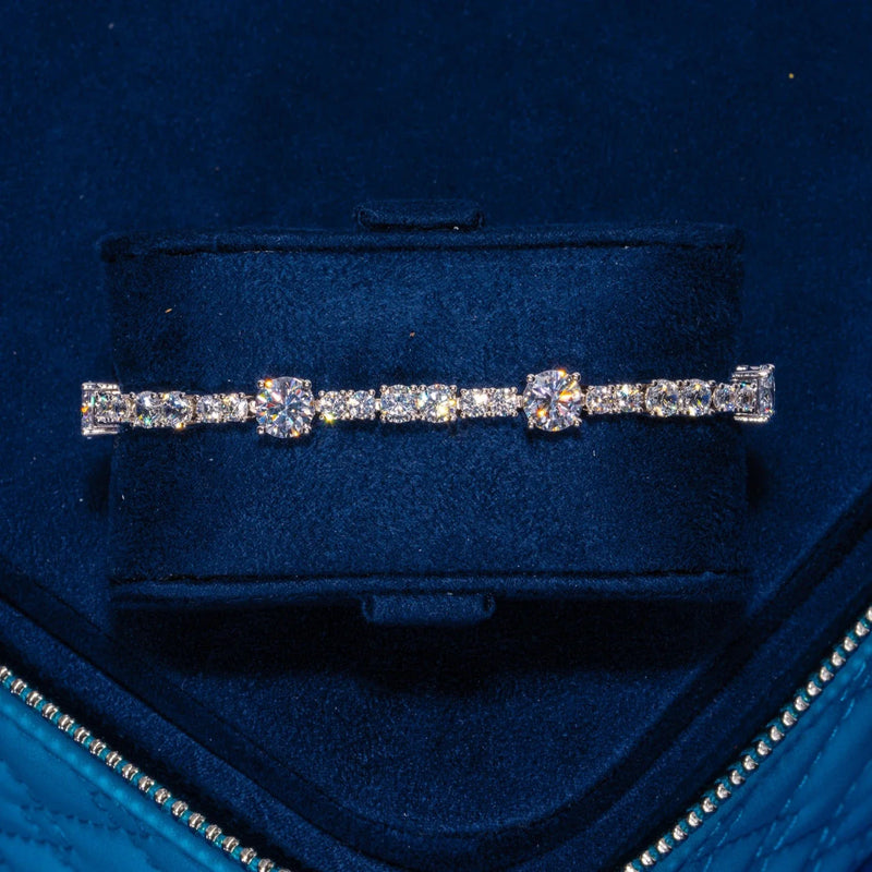 Gem Stationed Tennis Bracelet in white gold with sparkling CZ stones on navy velvet background