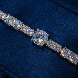 Gem Stationed Tennis Bracelet in white gold with evenly placed sparkling CZ stones on blue velvet background