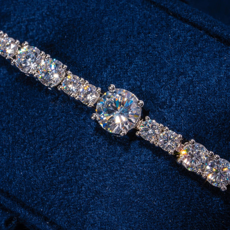 Gem Stationed Tennis Bracelet in white gold with evenly placed sparkling CZ stones on blue velvet background