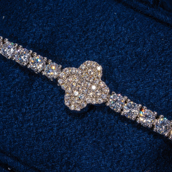 3MM Moissanite iced motif tennis bracelet in 925 silver with white gold plating on dark blue background