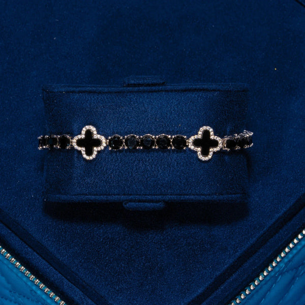 5MM black four leaf clover tennis bracelet in white gold with CZ stones on navy blue background