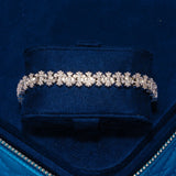 8.5MM Iced Out Cross Link Bracelet in white gold with CZ stones on navy velvet display box