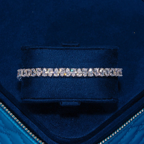 6MM Pear Cut Tennis Bracelet in white gold with sparkling stones in a blue jewelry box